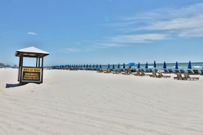 A beach with a sign offering chair rentals, pontoon boats, and dolphin tours. - Boardwalk 4 Bedroom 3 Bath End Unit Sleeps 12! (Panama City Beach)
