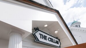 A building with a sign reading "THE CELLAR" and a wooden gate. - The Bell Inn (Peabody)