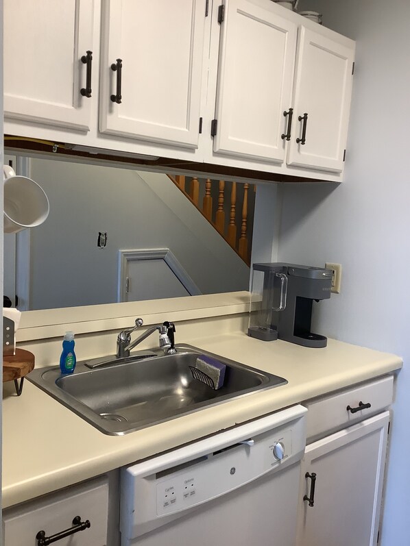 A kitchen with white cabinets, a stainless steel sink, a coffee maker, and a dishwasher. - Sugar Ski Premium Loft - Unit 11-703 (Sugar Mountain)