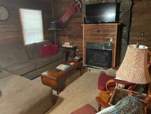 Relax in this inviting living room with a comfortable sofa, coffee table, and fireplace.