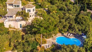 A modern two-story house with a swimming pool surrounded by dense greenery. - Villa Pelago - Three Bedroom Villa, Sleeps 6 (Skopelos)