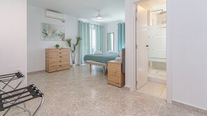 A modern bedroom with a bed, bedside table, dresser, and a shower area. - Presidential suite in the Plaza of Villamartin. Front line Golf. No noise. (Villamartín)