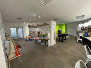 A room with a play area, a pool table, and a computer desk. - Disney Gateway -Shuttle to park-Pool- Free parking (Kissimmee)