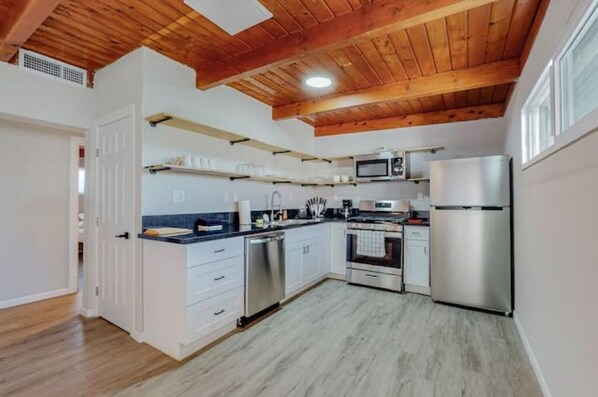 Enjoy cooking in this well-equipped kitchen with a dishwasher, oven, microwave, and refrigerator.