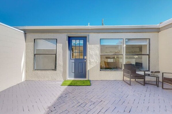 Stylish entrance with a single door, window, and seating area.