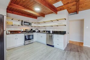 Enjoy cooking in this well-equipped kitchen with a microwave, dishwasher, and sink.