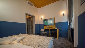 A hotel room with a bed, a desk with a computer, and a television. - Maria Luisa by INTROVERT HOTELS (Sofia)