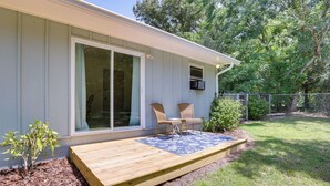 A house with a wooden deck, two wicker chairs, and a small plant. - Pet-Friendly Alabama Retreat w/ Deck & Patio! (Moody)