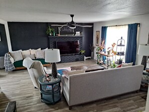 Relax in a cozy seating area with a sofa, armchairs, and a fireplace.