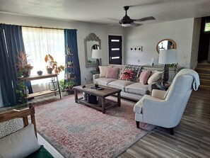 Relax in this inviting living room with a comfortable sofa set, coffee table, and side table.