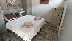 A bedroom with a bed, a ceiling fan, a dresser, and artwork on the walls. - Mare Verde A10 (Costa Adeje)