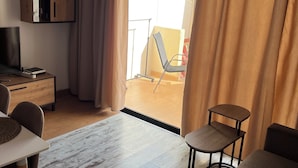 A modern living room with a sofa, a small table, a TV, and a wooden cabinet. - Mare Verde A10 (Costa Adeje)