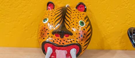 A ceramic tiger head with a yellow background.