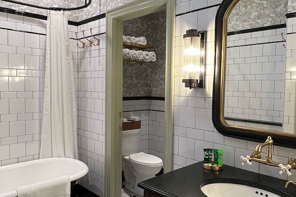 Bathtub, eco-friendly toiletries, hair dryer, towels