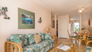 A living room with a sofa, chairs, and a dining area with a table and chairs. - Shipyard in Key West, FL (Key West)