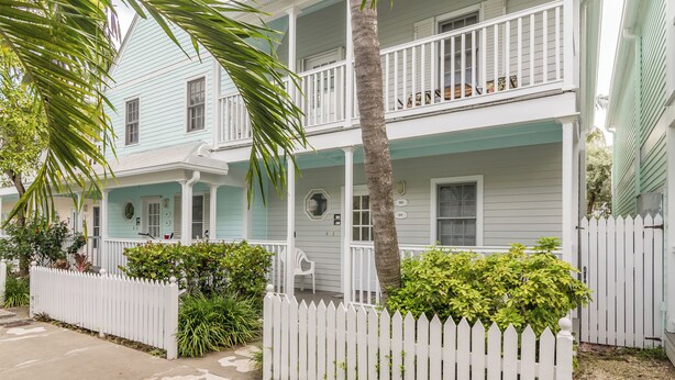 A two-story house with a white picket fence, a porch, and a balcony. - Shipyard in Key West, FL (Key West)