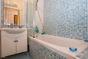Bathtub, hair dryer, towels