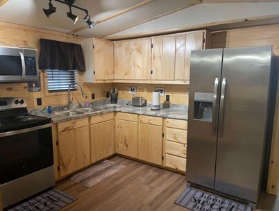 3BR, 2 Bath Cabin with full kitchen, living room, and hot tub.