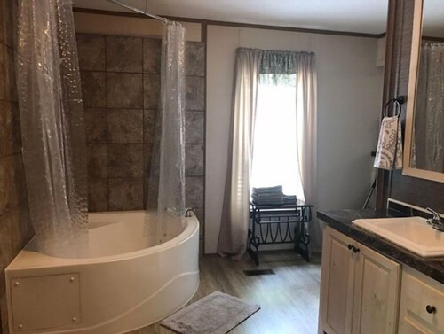 3BR, 2 Bath house with full kitchen, living room, and hot tub.
