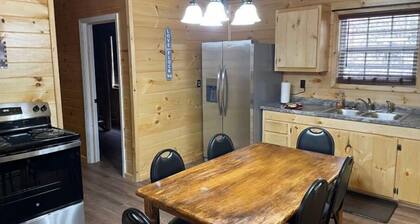 2BR 1 Bath cabin w/ full kitchen, hot tub, and living room.