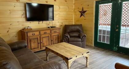 2BR 1 Bath cabin w/ full kitchen, hot tub, and living room.