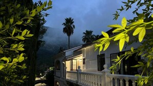 A traditional white building with a balcony, surrounded by lush greenery and a mountain backdrop. - Villa GAN EDEN a gem in a privileged environment (Barx)