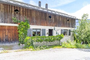 A rustic building with a wooden facade, a covered entrance, and a sign reading 'Les Sapins.' - LES SAPINS - UGINE - Gîte (UGINE)