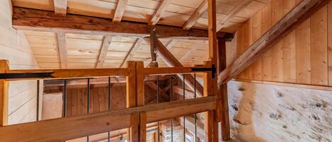 A wooden interior with exposed beams and a rustic aesthetic.