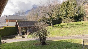 A traditional Japanese-style house with a tiled roof, surrounded by a well-maintained lawn and a small garden area. - LA PLANTAZ - CLERY - Gîte (CLERY)
