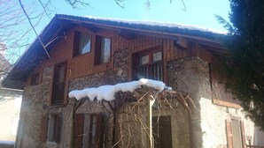 A rustic stone building with wooden shutters and a snow-covered roof. - CHEZ MARIE - LA TRINITE (LA TRINITE)