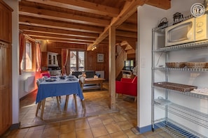 A wooden interior with a dining area, kitchen, and living space.