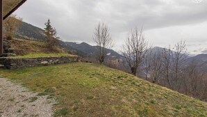 A mountainous landscape with a stone wall and a grassy slope. - CHALET DES CIMES - NOTRE DAME DU PRE (NOTRE DAME DU PRE)