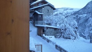 A snow-covered mountain village with traditional stone buildings and wooden structures. - LE MAZOT - VILLAROGER (VILLAROGER)