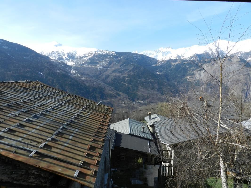 A mountainous landscape with snow-capped peaks in the background.