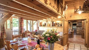 A wooden interior with a dining area, a kitchen, and a living space.