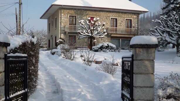 A stone house with a snow-covered roof and a balcony. - MUSCARIS - AIX LES BAINS (AIX LES BAINS)