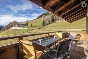 Enjoy al fresco dining with a table and chairs on this deck overlooking the surrounding hills.