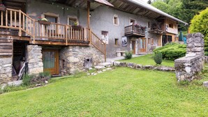 A rustic stone building with wooden balconies and a stone staircase leading to the entrance. - LOU MANSOU - LA MOTTE EN BAUGES (LA MOTTE EN BAUGES)