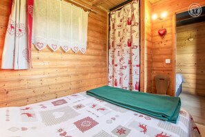 Enjoy a comfortable stay in this well-appointed room with a neatly made bed and a window offering a view.