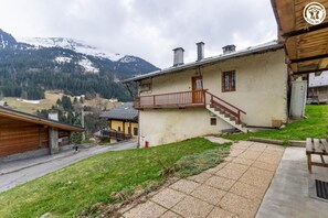 A chalet-style building with a balcony, a staircase, and a view of snow-capped mountains. - THE ATTIC - HAUTELUCE LES SAISIES (HAUTELUCE LES SAISIES)