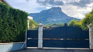 A gated entrance with a mountain in the background.