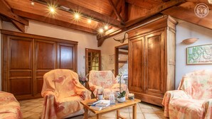 A cozy room with wooden furniture, a wooden table, and a map on the wall.