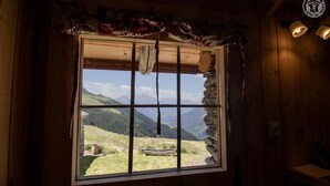 A rustic wooden room with a large window overlooking a mountainous landscape. - LA CHIRA - VAL CENIS (VAL CENIS)