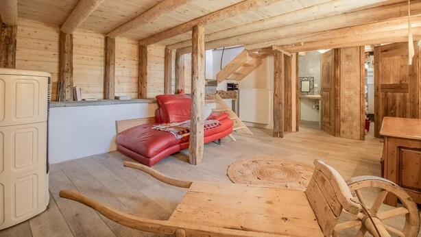 A wooden interior with a bed, a dining table, and a kitchen area. - LA CHIRA - VAL CENIS (VAL CENIS)