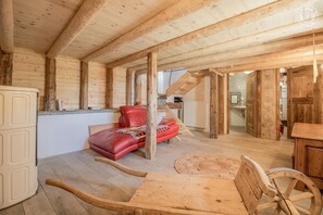 A wooden interior with a bed, a dining table, and a kitchen area. - LA CHIRA - VAL CENIS (VAL CENIS)
