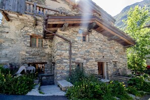 A stone building with wooden beams and a rustic exterior.
