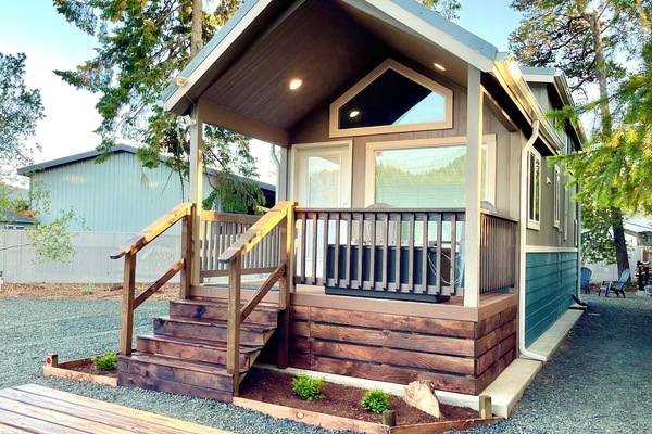 Welcome to Tiny Pines! Enjoy the spacious yard, front porch, and picnic area.