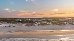 A coastal property with multiple large houses, a beach, and dunes. - Hemingway & Mark Twain Estate | Weddings & Events | 32BR Sleeps 72 | OBX (Corolla)