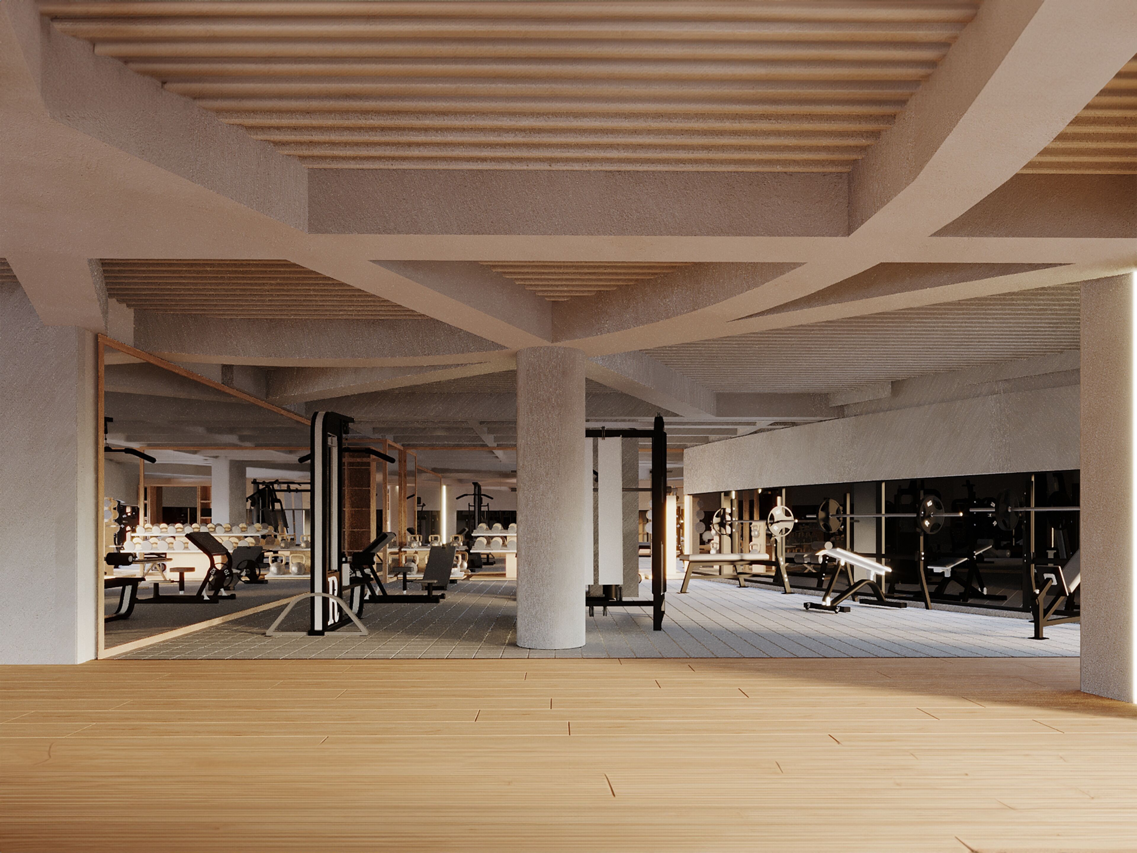 A spacious gym with various exercise equipment, large pillars, and a wooden floor.