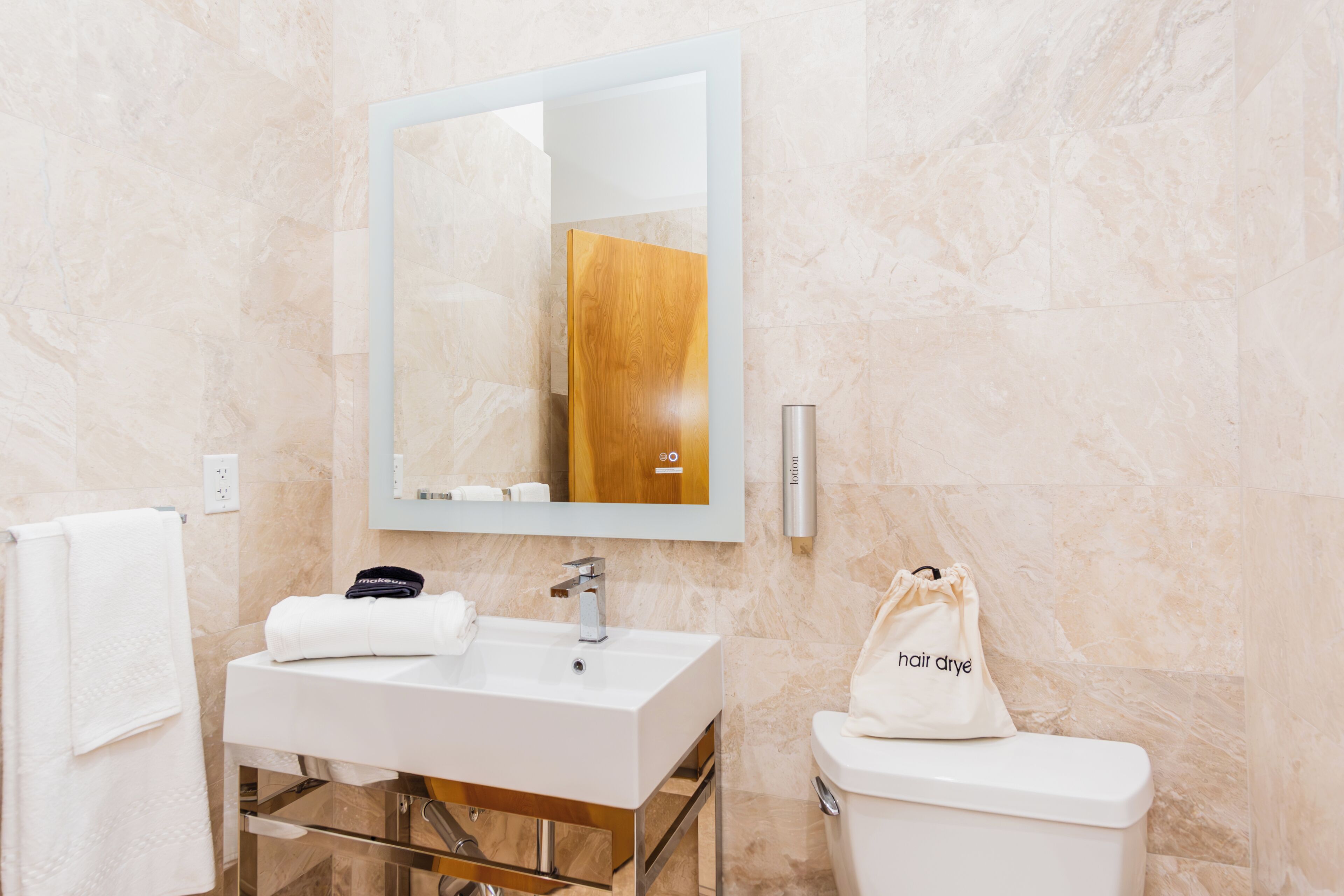 Ein modernes Badezimmer mit Waschbecken, Spiegel und Toilette.
